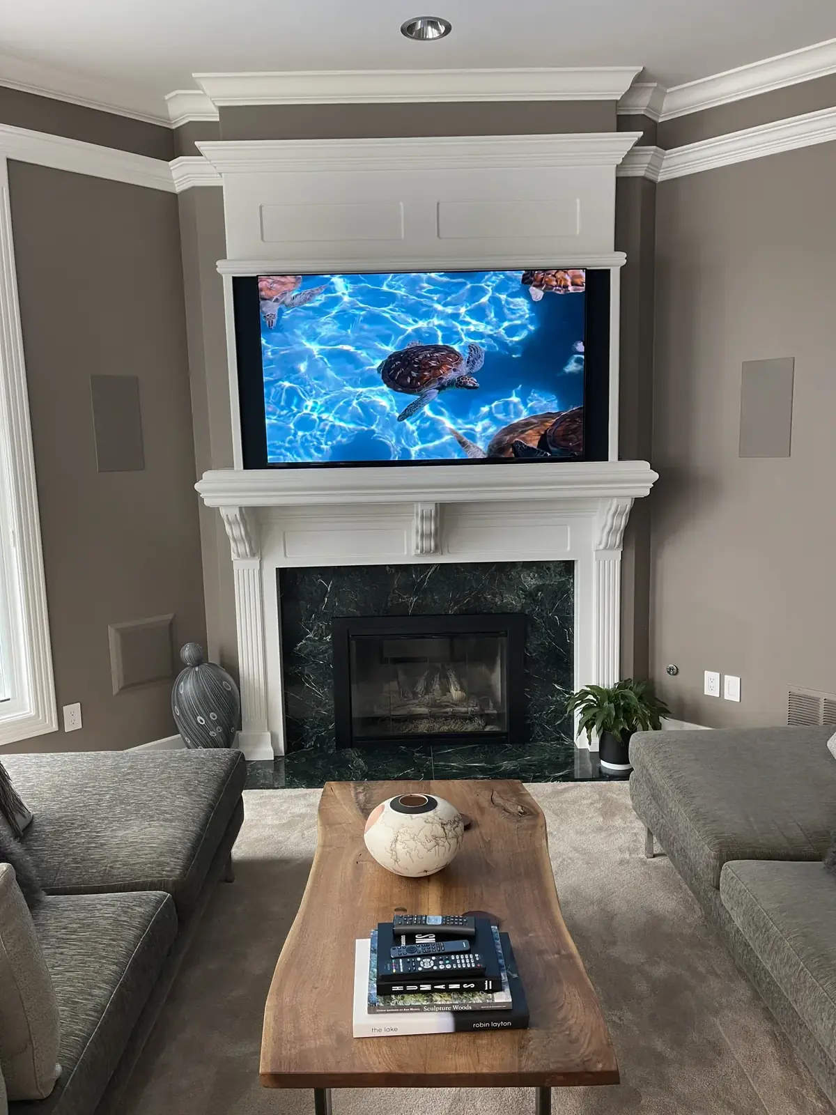 TV mounted above a white fireplace mantel in a living room, Kirkland