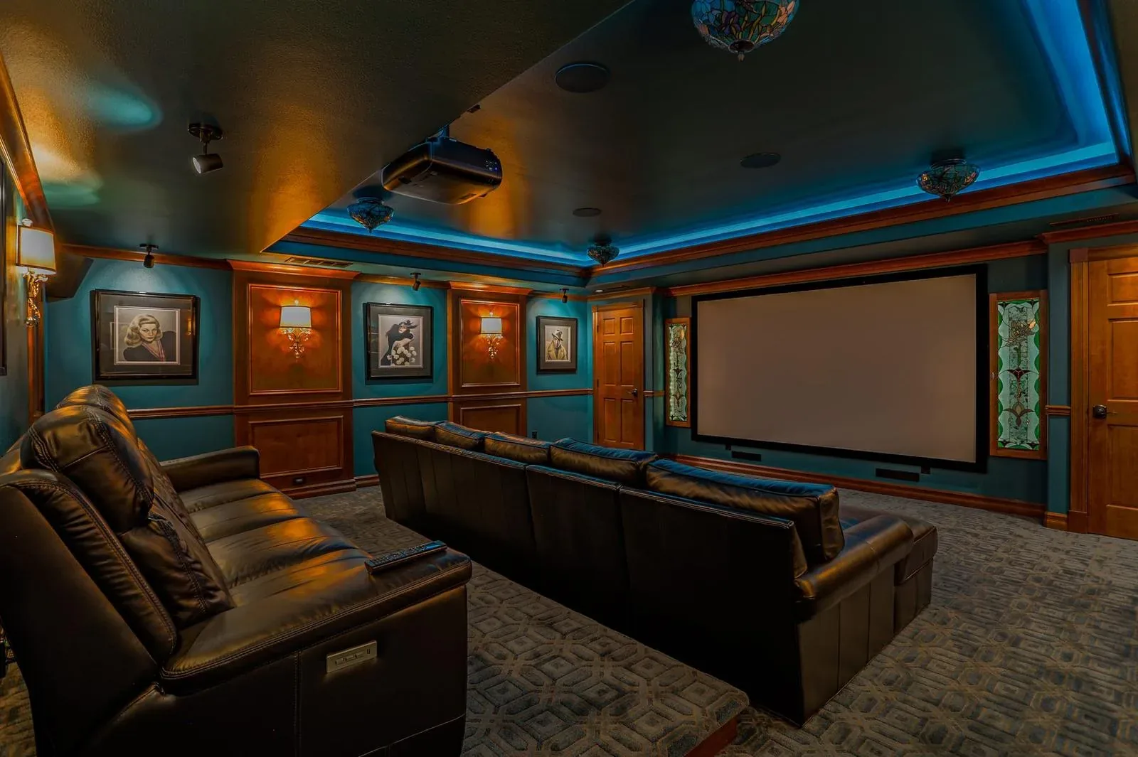 Home theater with cove lighting, a projection screen and leather seating, Marysville