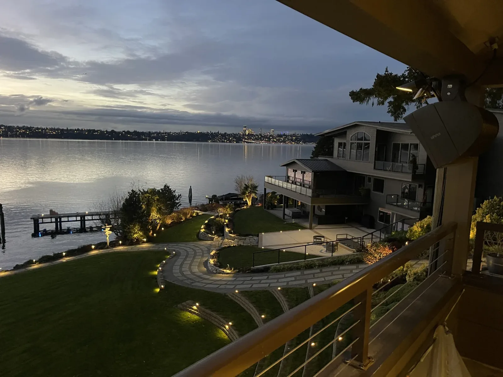 Outdoor speaker under the eave of a deck overlooking the lake at dusk, Mercer Island