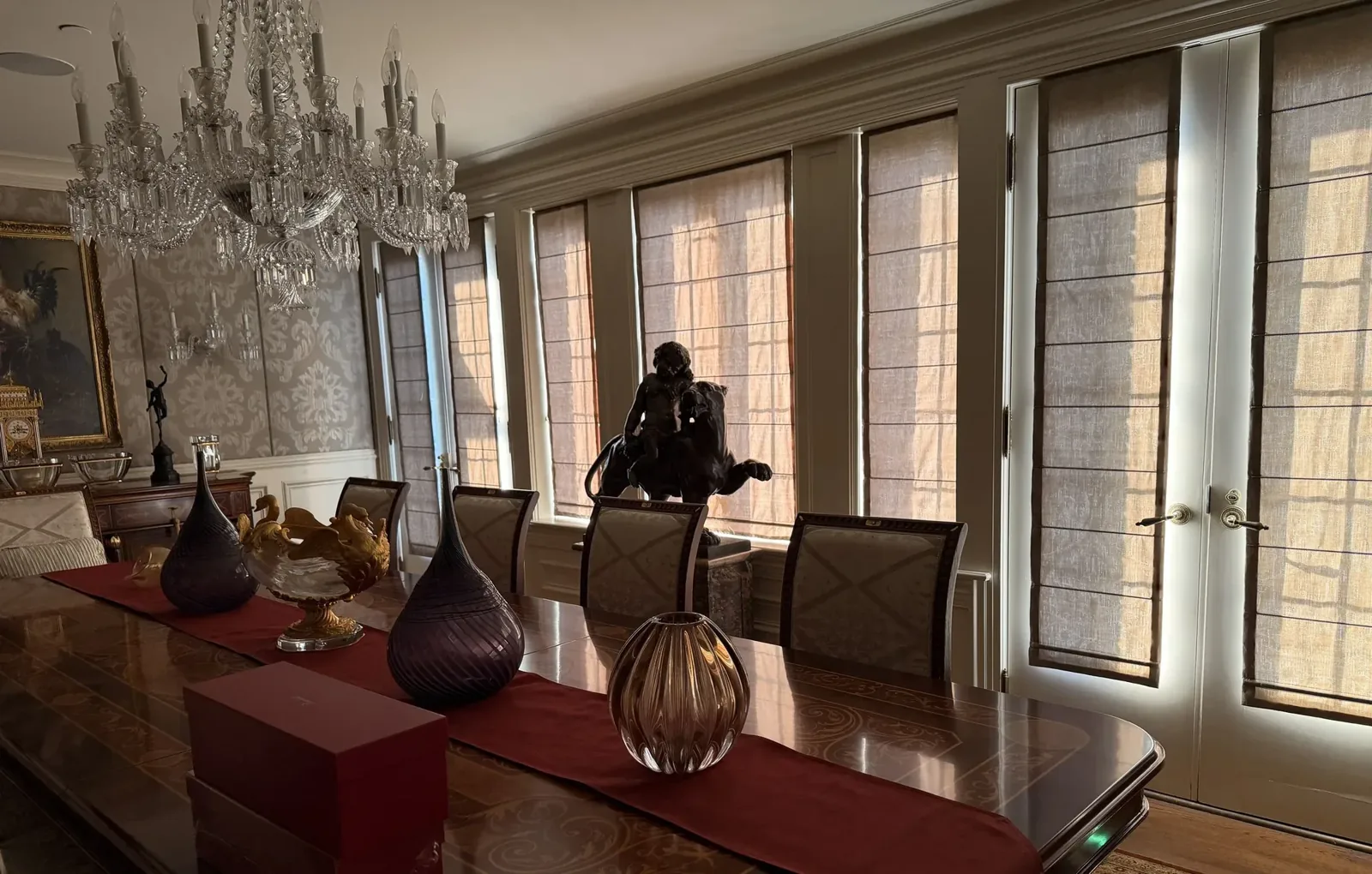 Dining room with a wall of motorized roman shades, half lowered, Mercer Island