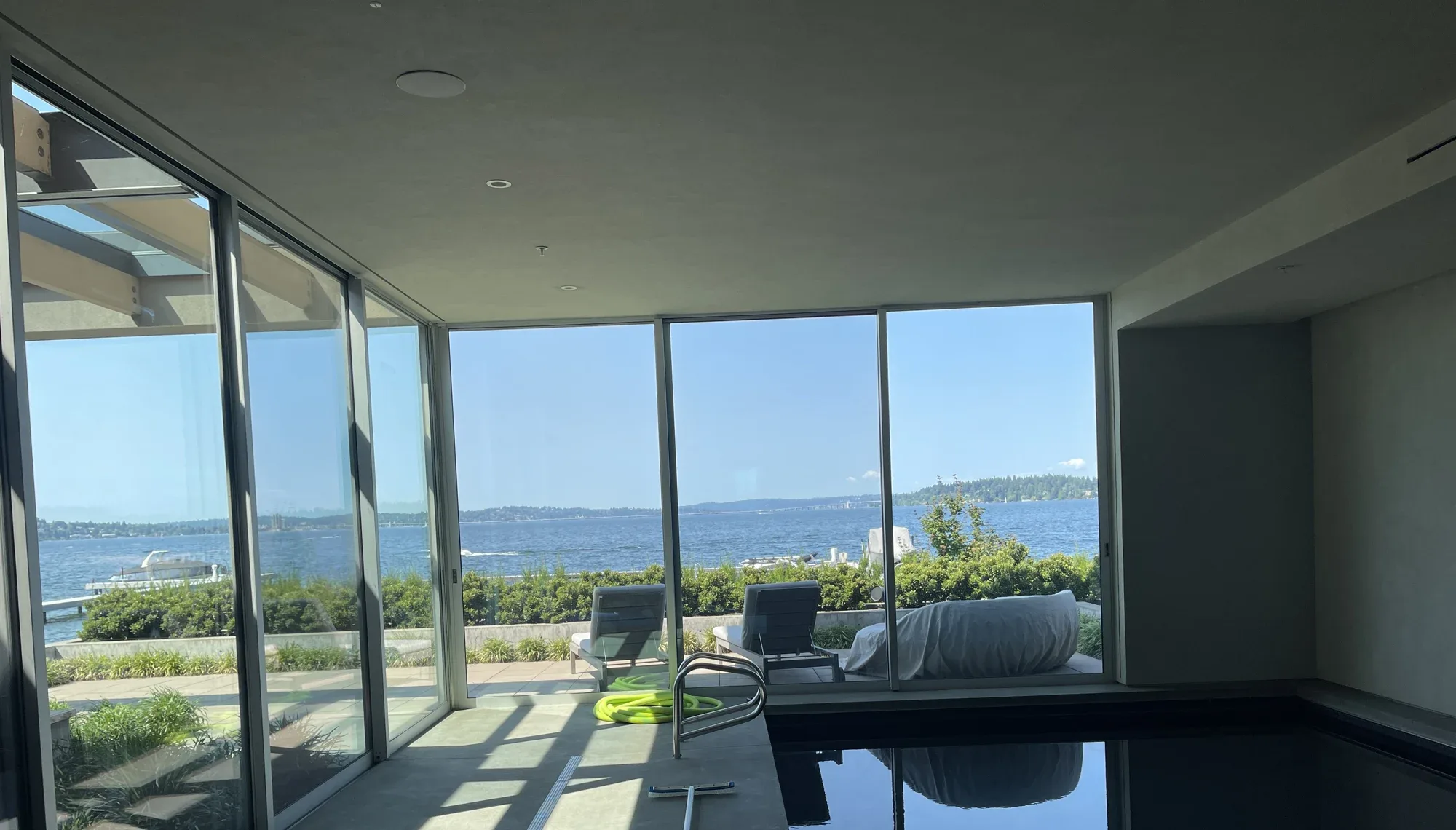 Indoor pool with a wall of floor-to-ceiling windows facing the lake, Mercer Island