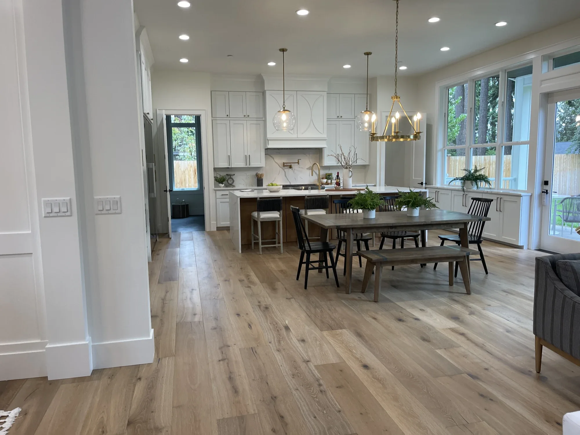 Bright open kitchen and dining room in a home with whole-home audio, lighting control, security, cameras, network and smart locks, Mercer Island