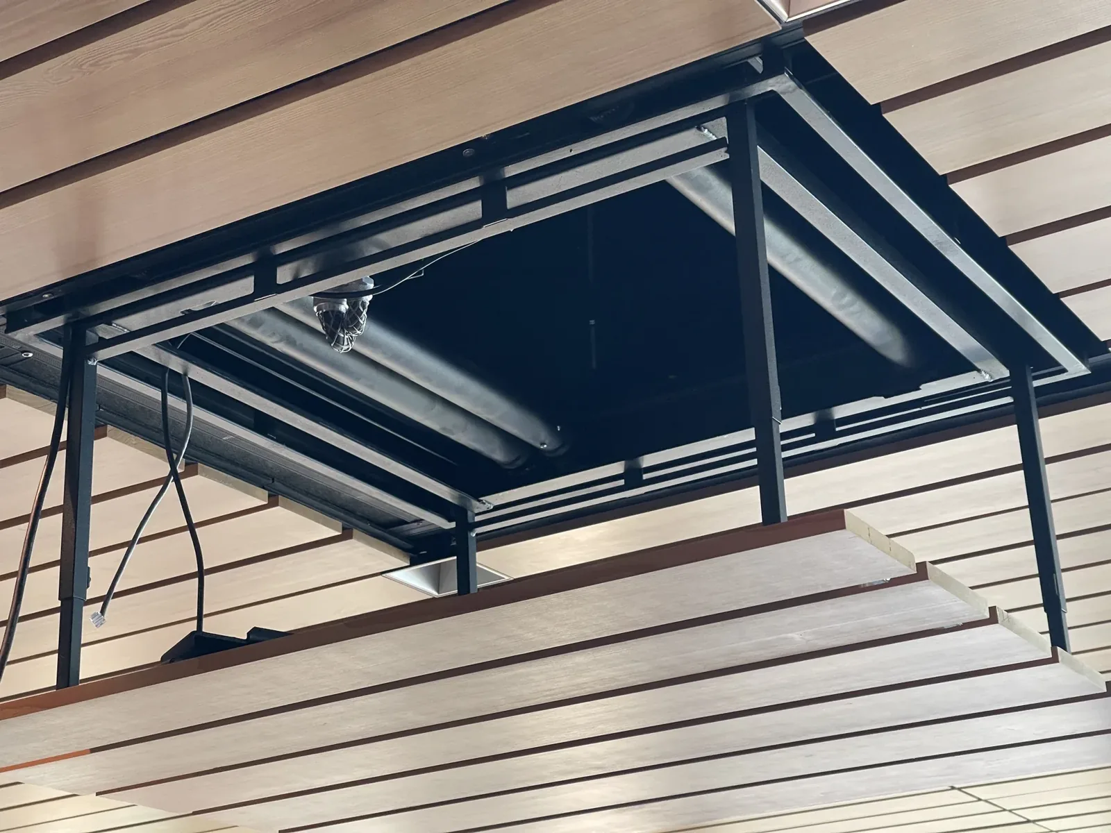 Projector lowering from a wood ceiling on a motorized lift, Mercer Island