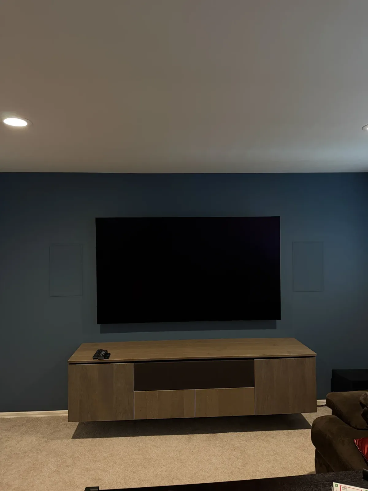 Media wall with a large TV and in-wall speakers, Mill Creek