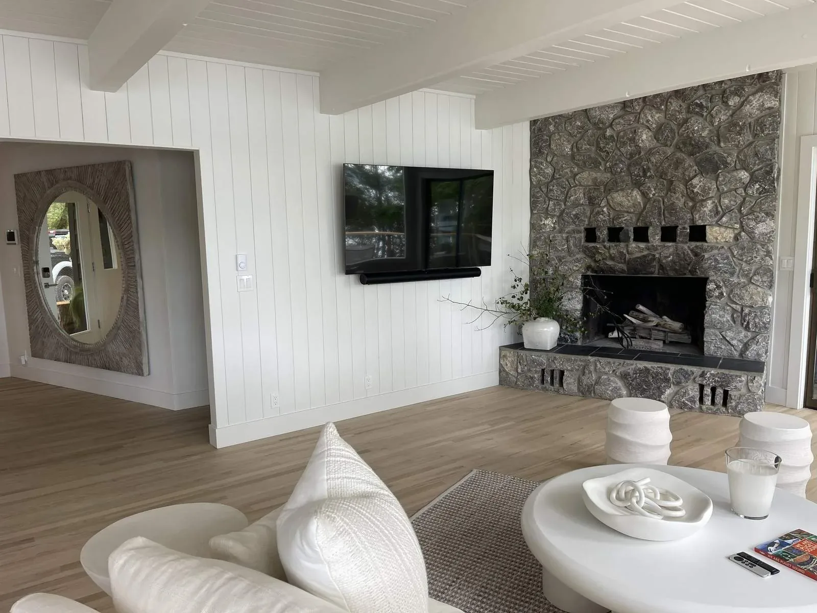 Living room TV mounted over a fireplace in a vacation home, Orcas Island