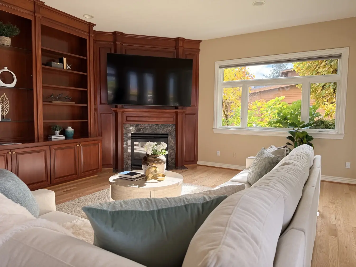 Family room TV mounted above a fireplace in custom cabinetry, Sammamish
