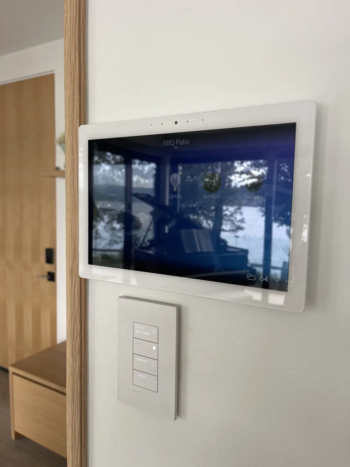 Wall touchscreen above a scene keypad beside an entry door, Sammamish