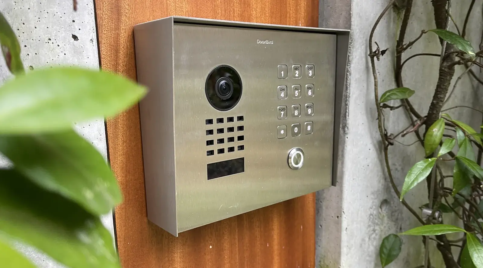 Stainless video door intercom with a camera and keypad beside a front entry, Seattle
