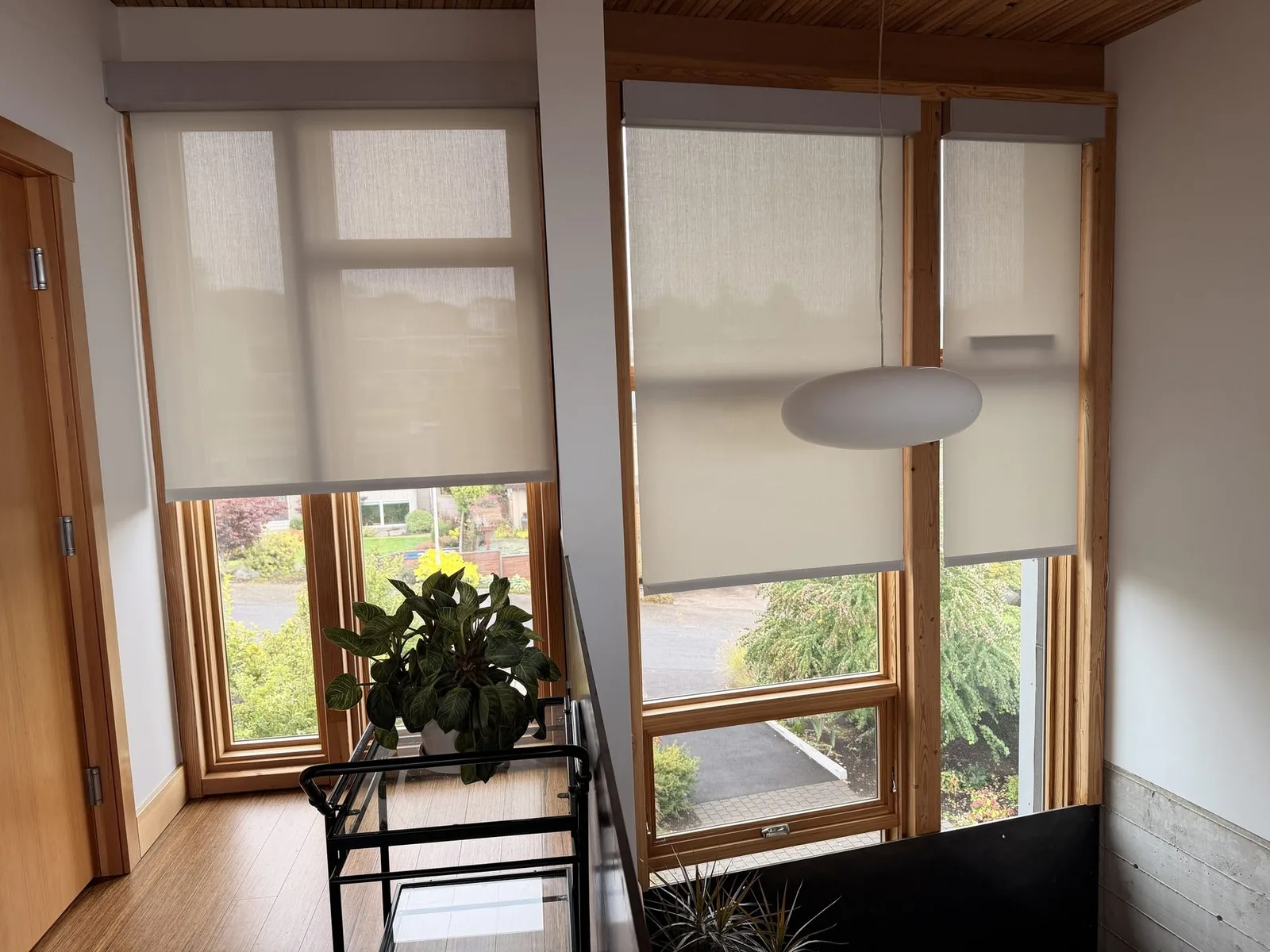 Roller shades lowered over tall windows, Seattle